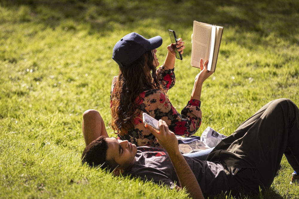 Students laying in the quad in the sunshine