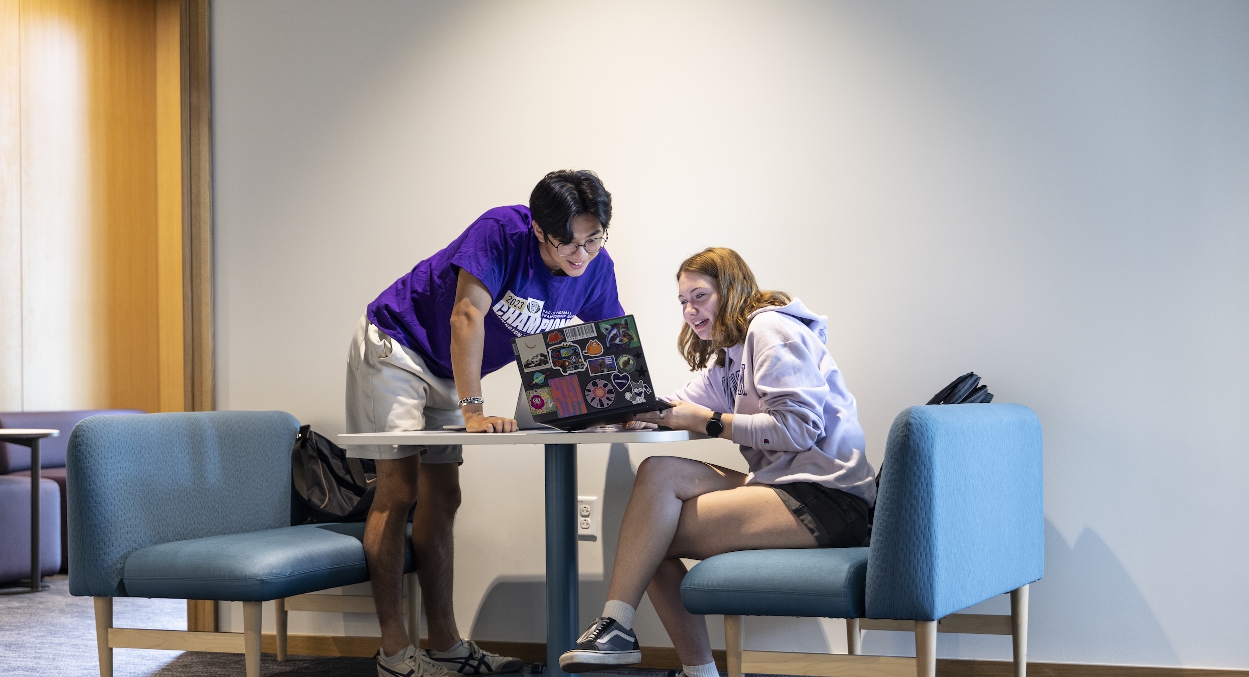 students looking at a laptop together
