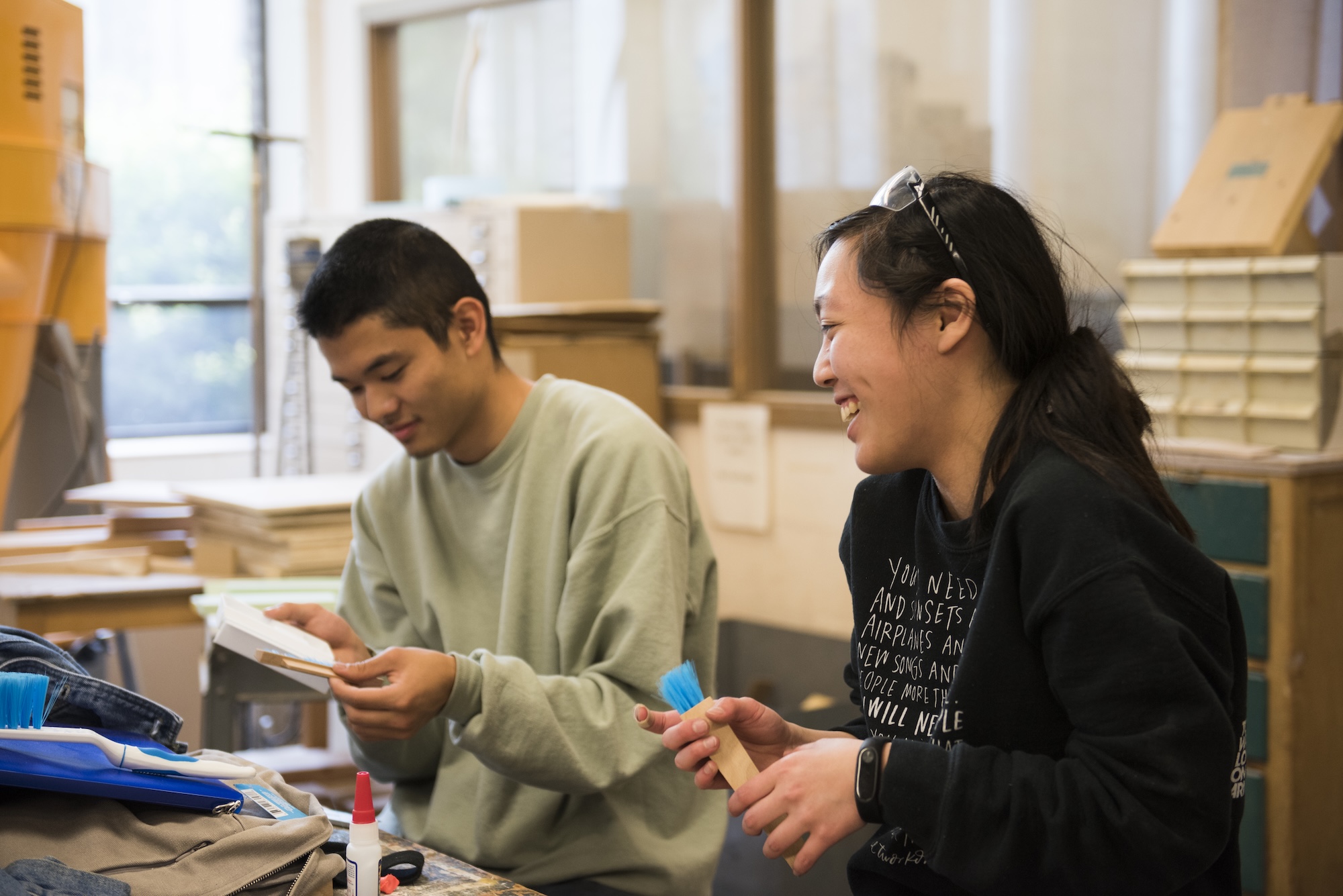 Students in the Woodshop, laughing with one another