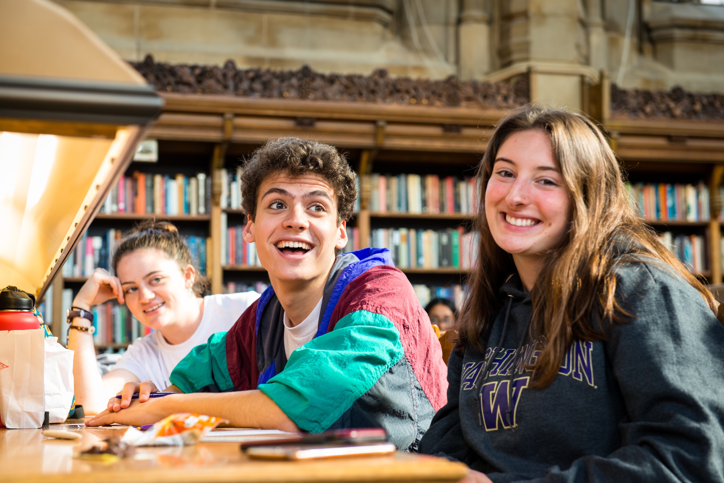 Students sitting together in Suzzallo, smiling
